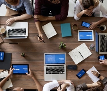 people working together with their laptops on a table